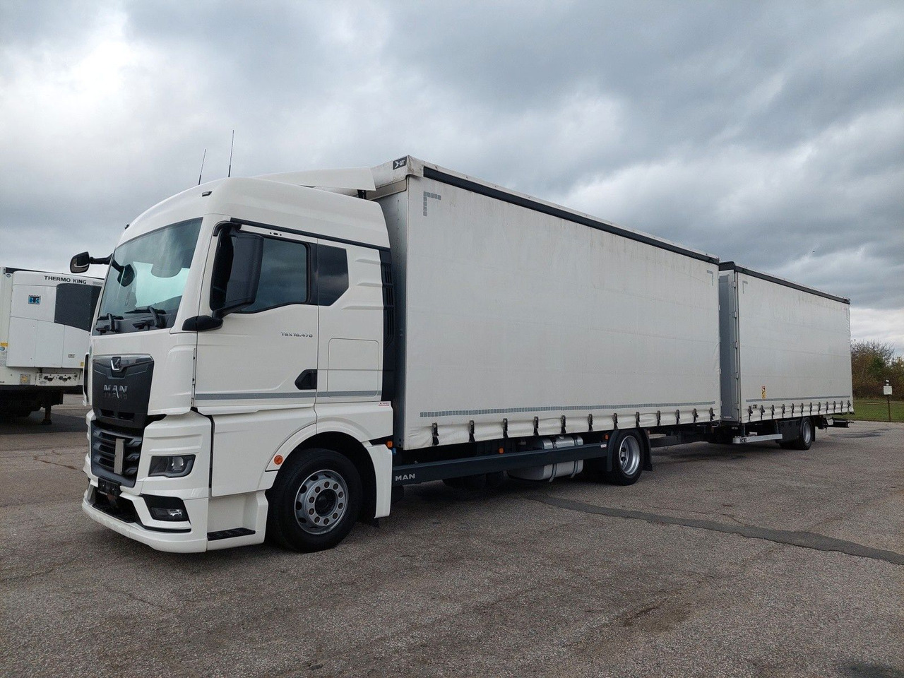 MAN TGX 18.470 LL + Gniotpol G-4080 120 m3 Durchbar - Camión lona: foto 1 MAN TGX 18.470 LL + Gniotpol G-4080 120 m3 Durchbar - Camión lona: foto 1